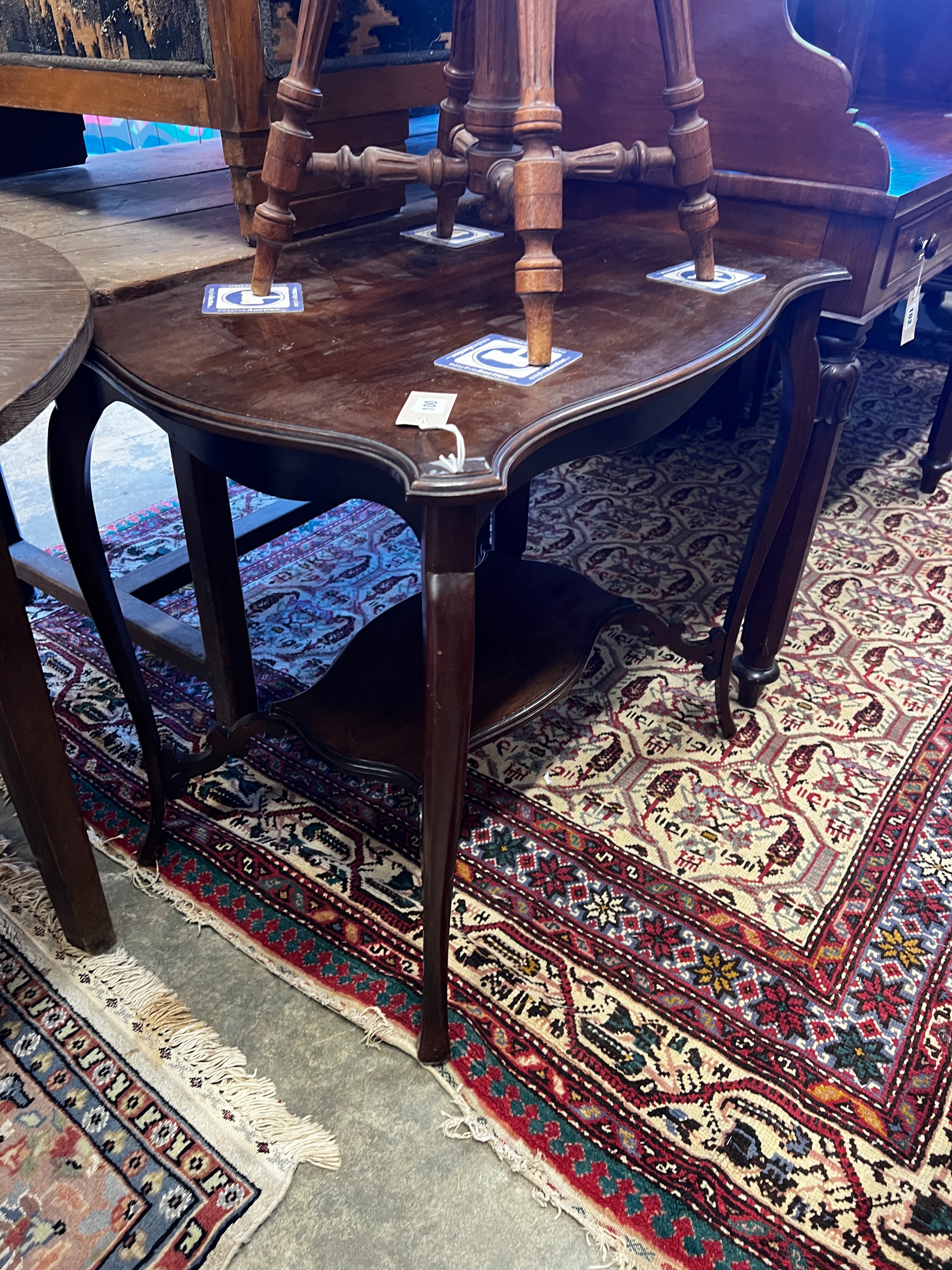 A late 19th century French walnut revolving adjustable piano stool and a Victorian mahogany centre table